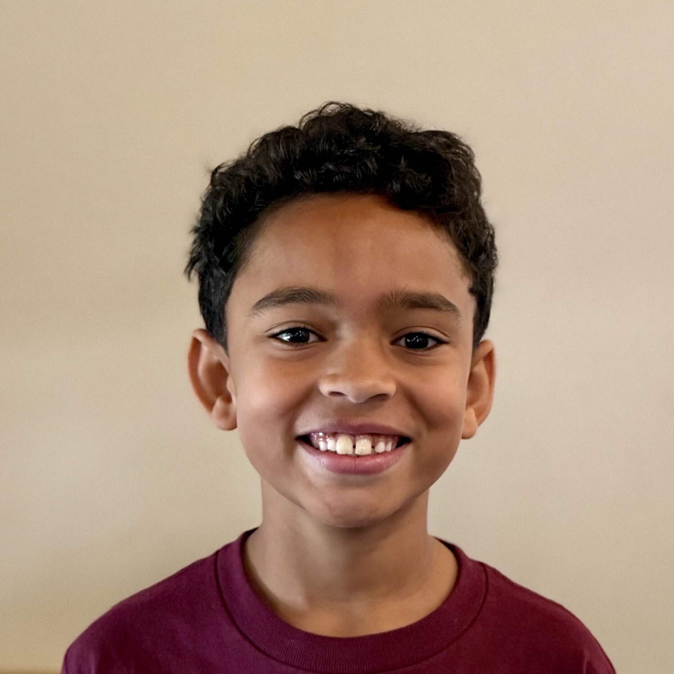 Male, middle-school student smiling at camera