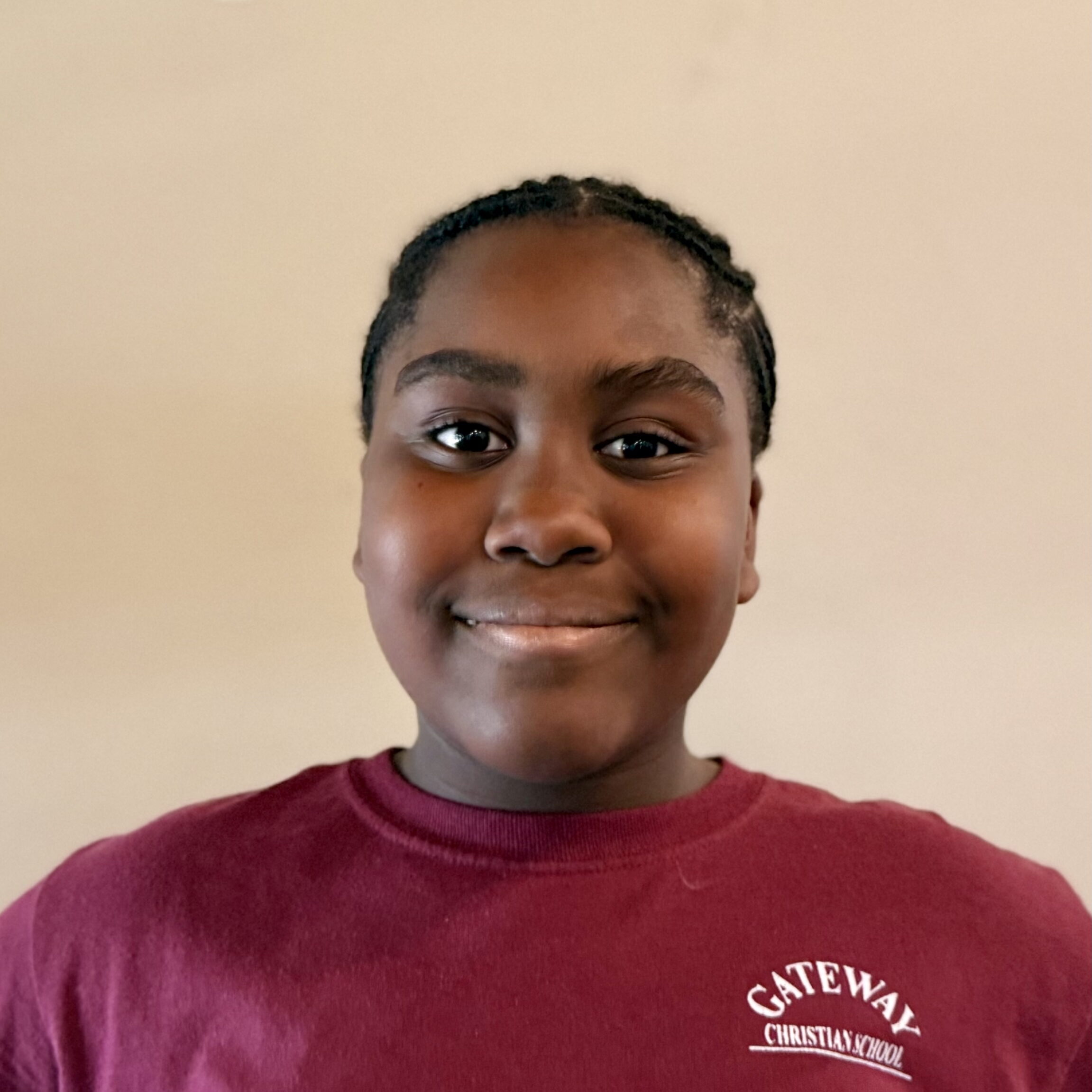 Female, middle-school student smiling at camera