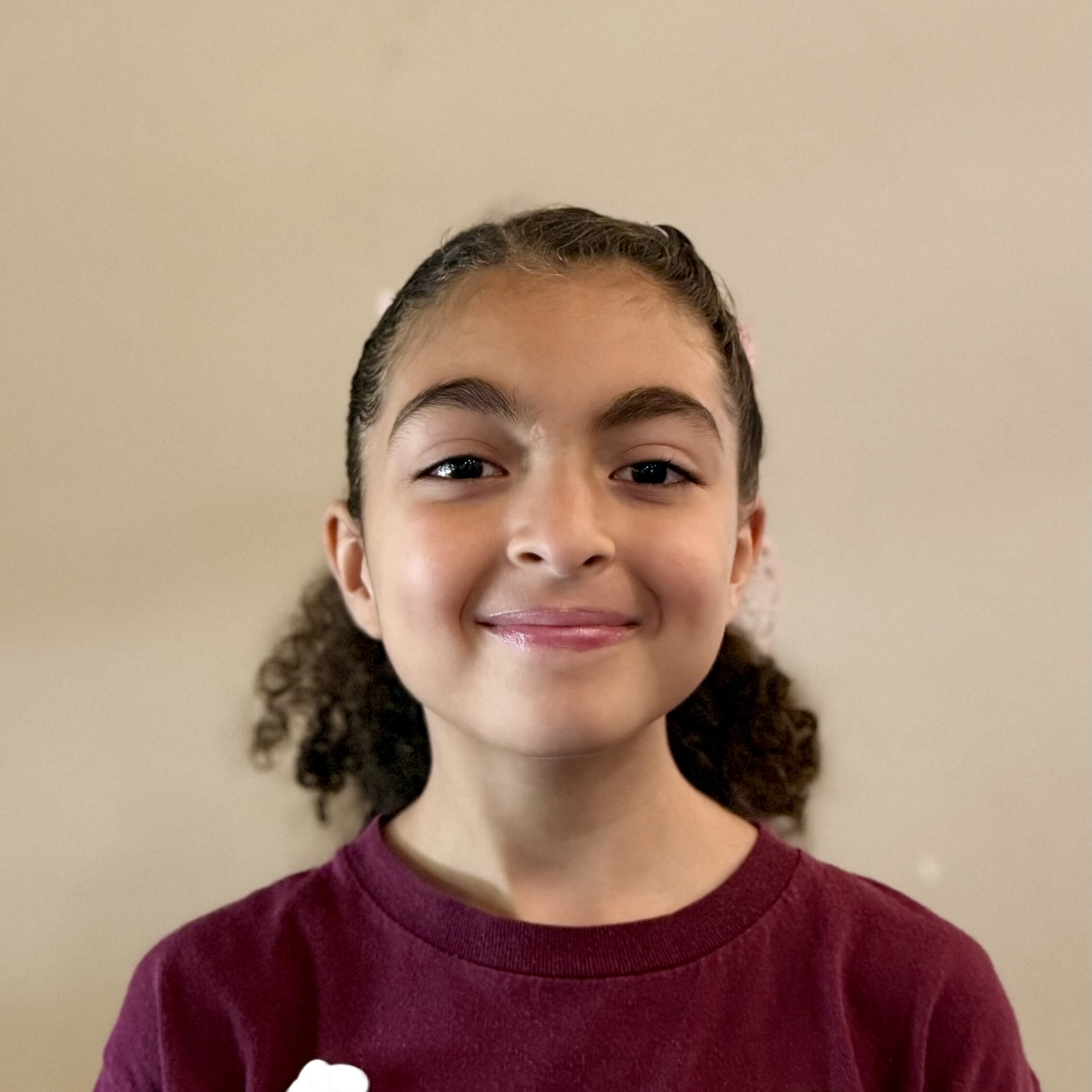Female, middle-school student smiling at camera